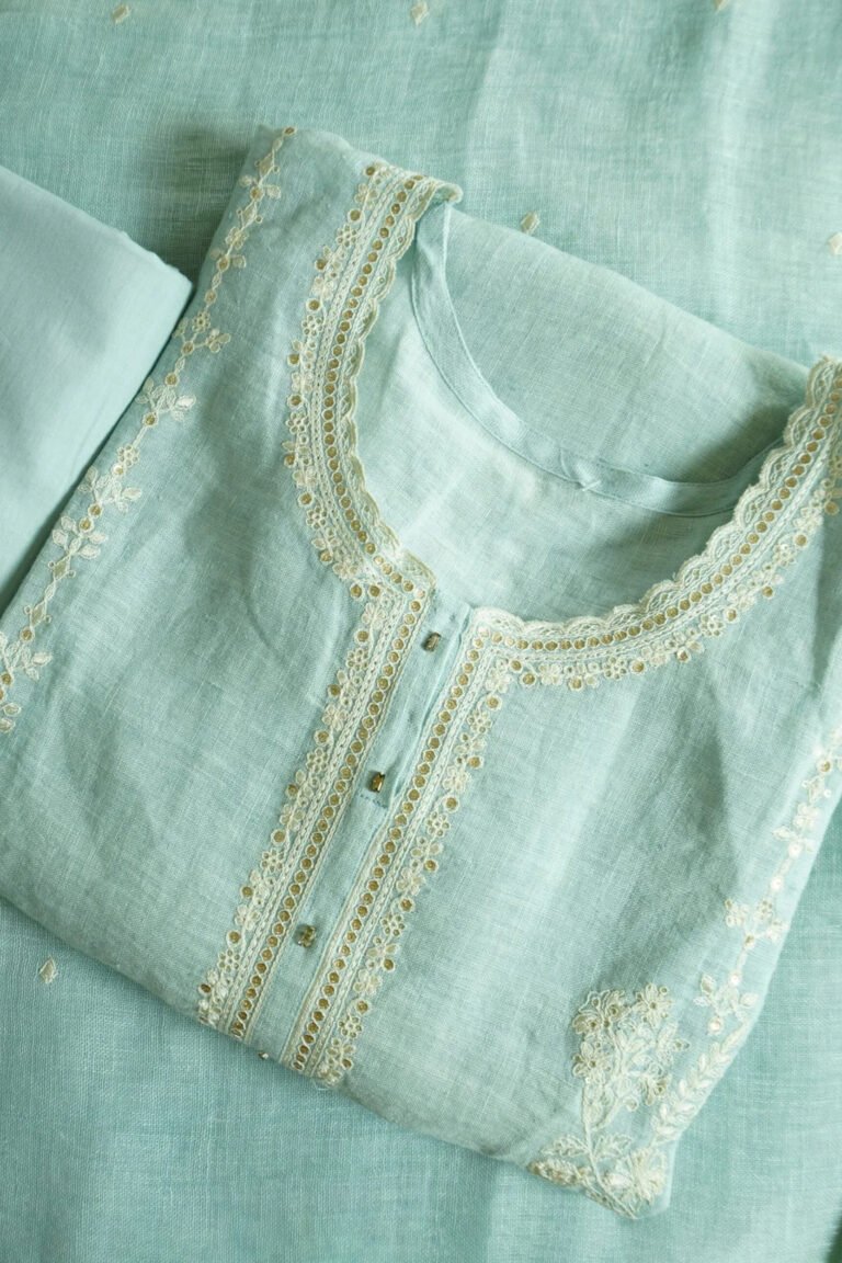 Traditional kurti named "Kanya," featuring intricate embroidery along the neckline, placket, and sleeves. Lightweight and graceful, it blends timeless craftsmanship with a minimalist silhouetteโideal for warm-weather elegance.
