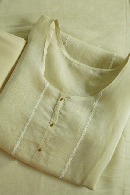 Semi-stitched kurti in a soft, light color with subtle embroidery along the neckline, suitable for festivals, traditional events, and stylish ethnic wear for women.