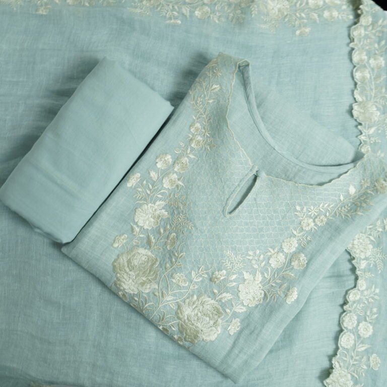 Blue semi-stitched kurti with white floral embroidery, matching bottom fabric, and embroidered dupatta displayed flat.