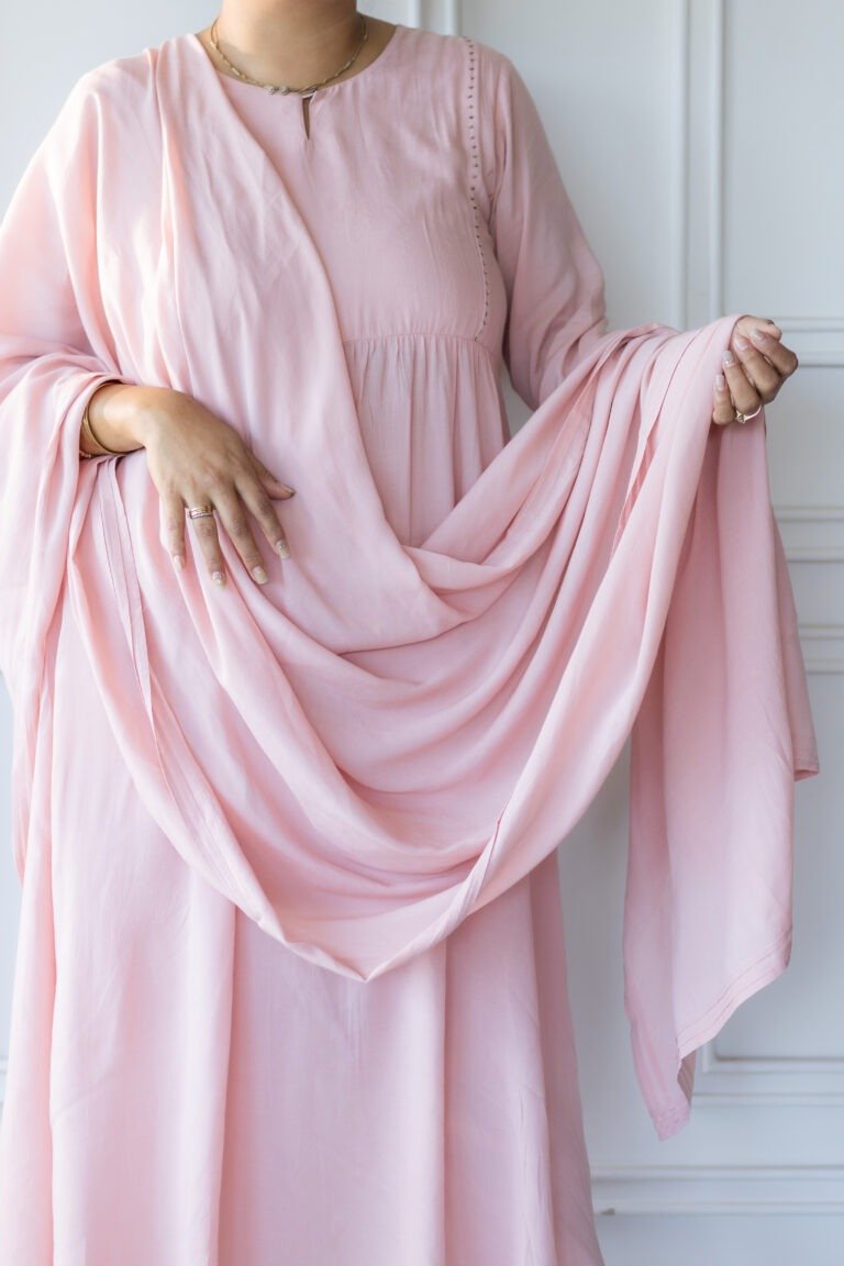 Woman wearing Sharvani blush pink kurti with draped dupatta