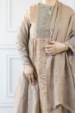 Side profile showing sleeve cuff embroidery and gold bangles