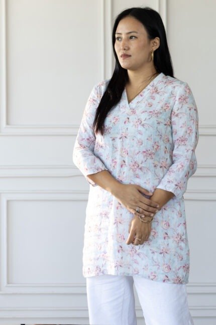 Side profile of model wearing Lumi kurti, showcasing sleeve length and relaxed fit.