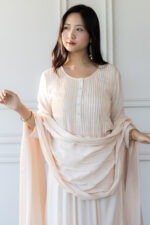Woman wearing blush pink Pavitra Anarkali kurti with pleated bodice
