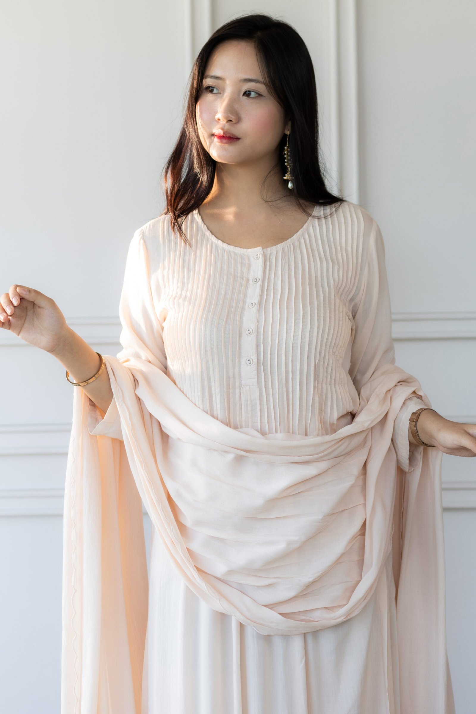 Pavitra Kurti – Front View Woman wearing blush pink Pavitra Anarkali kurti with pleated bodice