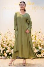 Model standing in front of boutique backdrop wearing Verdant Veil ensemble