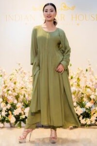 Model standing in front of boutique backdrop wearing Verdant Veil ensemble