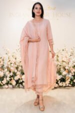 Model standing in front of boutique floral backdrop wearing Blush Raag
