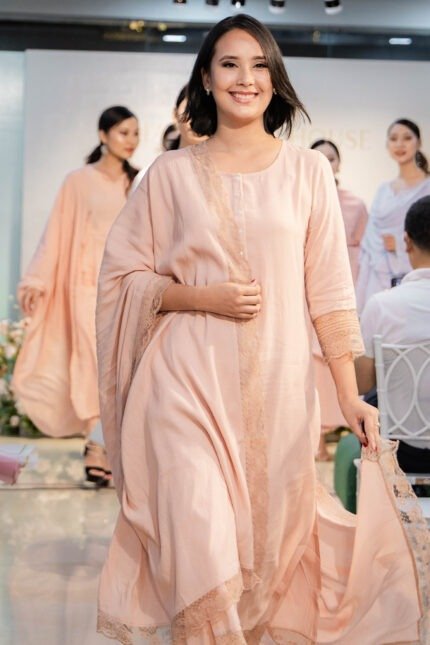 Model walking on runway in Blush Raag ensemble during fashion show