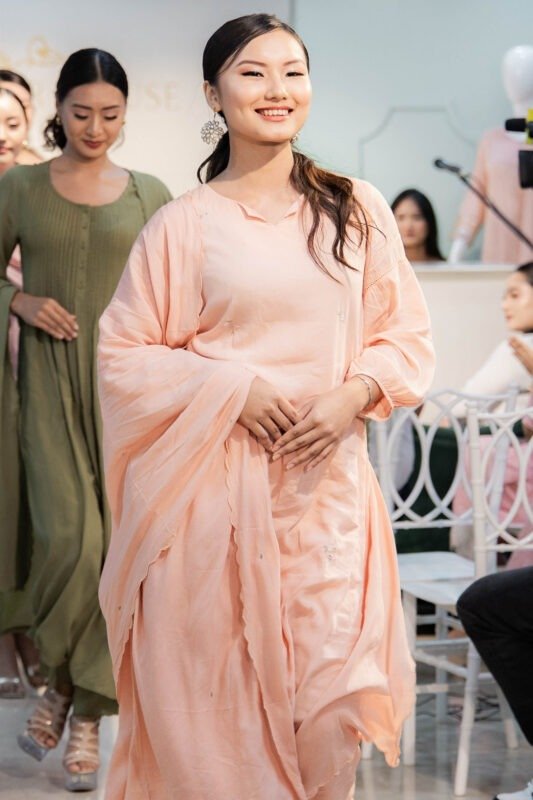 Model wearing Tehzeeb Taraana peach embroidered modal kurti set on runway with dupatta