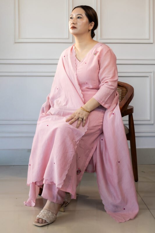 Seated pose highlighting the kurti’s flow and fabric texture