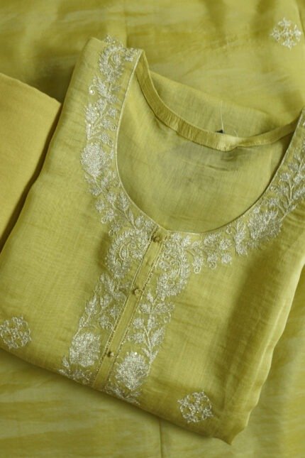 Semi-stitched saffron kurti with intricate silver embroidery along the neckline and front placket, suitable for festivals, traditional events, and stylish ethnic wear for women.