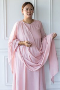 Editorial shot of Sharvani kurti in natural light against white paneled wall