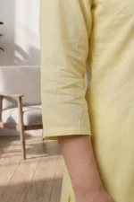 A close-up shot of the three-quarter length sleeve of the Canvas pale yellow kurti, showing the breathable linen-cotton fabric texture and clean hemline against a soft-lit indoor background.