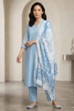 Full-length view of the light blue Edge linen kurti set with straight pants and a matching floral dupatta.