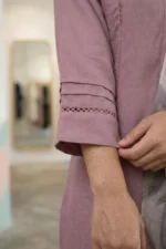 Close-up of intricate white floral embroidery on the sleeve of a mauve Rang kurti.