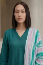 Woman wearing a teal Vogue linen kurti featuring a V-neckline and a multi-colored striped dupatta.