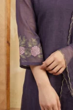 A focused shot of the three-quarter length sleeve, featuring a wide embroidered cuff with intricate floral and vine patterns. The fabric displays a soft, high-quality texture suitable for both professional and social occasions.