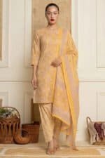 Model wearing yellow floral printed kurti set with V-neck kurta, matching pants and dupatta