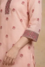 Close-up of the Blush Buti Kurta Set showing a three-quarter sleeve with a rich floral embroidered cuff band in deep rose and gold tones with sequin detailing on blush pink textured check cotton fabric with scattered pink buti print motifs