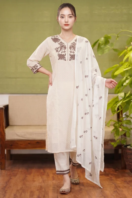 Full-length view of the Inaya ivory suit set with brown bird embroidery and a matching printed dupatta
