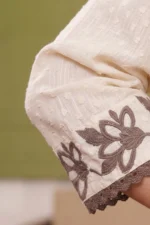 Detailed view of the Inaya kurta sleeve highlighting the floral embroidery border and dark brown crochet lace.