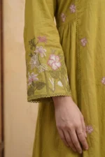 Close-up of the Sage Bloom Kurta Set showing a richly embroidered bell sleeve with pink, white and olive green floral and leaf threadwork with a delicate scalloped crochet hem border on olive green cotton fabric