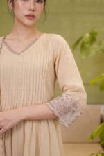 Detailed close-up of the sheer organza sleeve cuff on The Dune Kurti, showcasing intricate floral embroidery, delicate sequin work, and a scalloped edge finish.