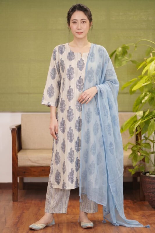 Full-length shot of the Azure Bloom kurti set featuring a beige base with blue floral motifs, matching printed trousers, and a lightweight sky blue dupatta.