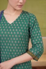 Macro shot of the Forest Flora kurti sleeve, highlighting the geometric patterned border at the cuff and the consistent leafy print across the emerald green base.