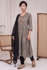 : Full-length view of the Graphite Mandala Kurti set, featuring an intricately printed grey and black A-line kurta, tailored solid black trousers, and a gracefully draped solid black dupatta with tassels.