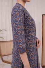 Detailed side angle of the Indigo Petal Kurti showcasing the classic three-quarter sleeves and the intricate reddish-brown and beige botanical motifs seamlessly printed across the deep indigo blue background.