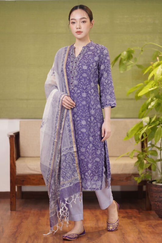 Full-length view of the Indigo Petal Set featuring a lavender floral kurta with a mandarin collar, striped trousers, and a matching printed dupatta.