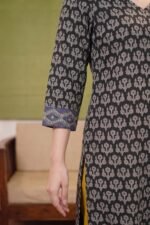 Detailed view of the three-quarter sleeves on the Midnight Buta Suit, showcasing the contrast blue geometric diamond-patterned border at the cuffs.