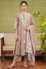 Full-length view of the Mocha Print Kurti set in an earthy brown tone, featuring large white abstract motifs, cowrie shell tassel detailing, matching straight trousers, and a coordinating printed dupatta.