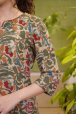 A detailed view of the three-quarter sleeves on the Mughal Garden Suit, highlighting the intricate floral trail patterns and premium breathable cotton fabric.