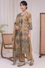 Full-length, angled view of a model wearing the complete Oasis Print Kurti set. The image captures the coordinated slate-green geometric patterns across the straight-hem kurti, the precise border print on the trousers, and the matching draped dupatta.