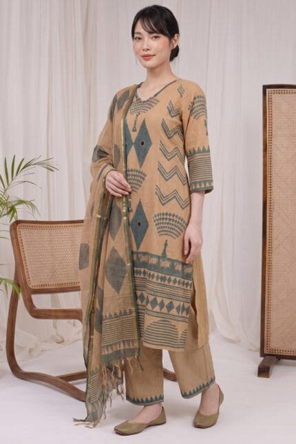 Full-length, angled view of a model wearing the complete Oasis Print Kurti set. The image captures the coordinated slate-green geometric patterns across the straight-hem kurti, the precise border print on the trousers, and the matching draped dupatta.