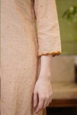 Detailed close-up of the 3/4 sleeve on the Sand Dot Kurti, highlighting the intricate contrast scalloped edge detailing on the sleeve hem and the delicate, scattered dot embroidery across the beige garment.