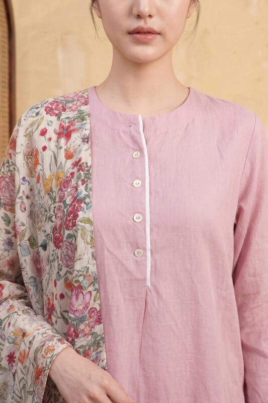 Detailed view of the dusty pink Loom Kurti yoke, highlighting the mandarin collar, white piped placket, and precise button alignment.