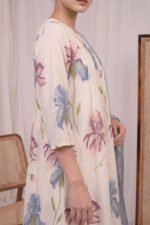 Side view of the Pintuck Iris Kurti showing the sleeve design and the flow of the iris floral patterns on premium cream fabric.
