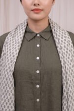 Close-up of the Sage Coord yoke and collar in olive green, highlighting the neat button-down placket and premium fabric finish.