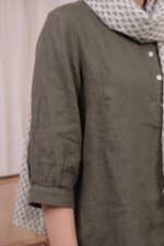 Close-up of the Sage Coord sleeve in olive green showing the fabric texture and the gathered cuff detail at the hem.